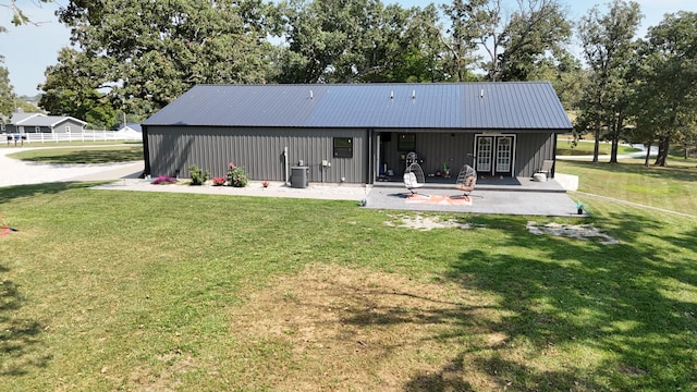 back of property featuring central AC unit and a lawn