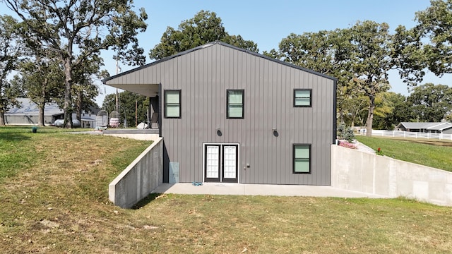 rear view of house featuring a yard and a patio