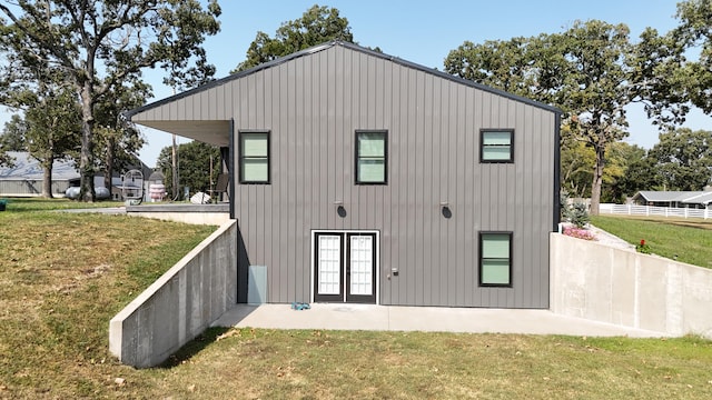 rear view of property with a yard and a patio area