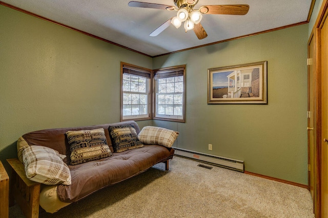 living area with ceiling fan, light colored carpet, ornamental molding, a baseboard heating unit, and a textured ceiling