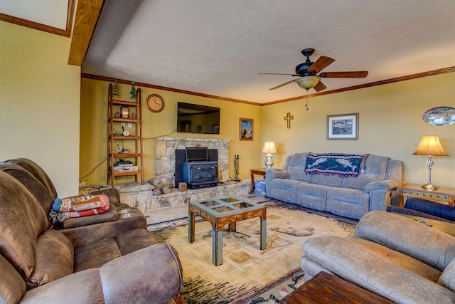 living room with a wood stove, crown molding, ceiling fan, and a textured ceiling