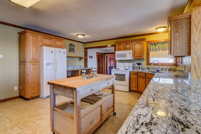 kitchen featuring white appliances, crown molding, sink, light stone counters, and a textured ceiling