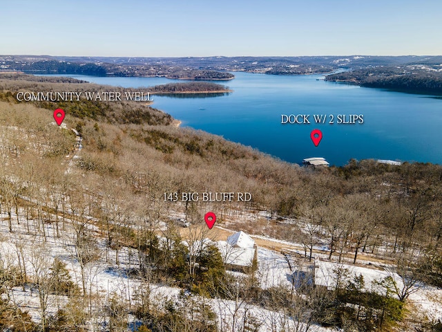 snowy aerial view with a water view