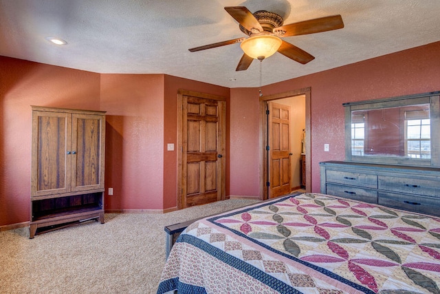 bedroom featuring ceiling fan, a textured ceiling, and light carpet