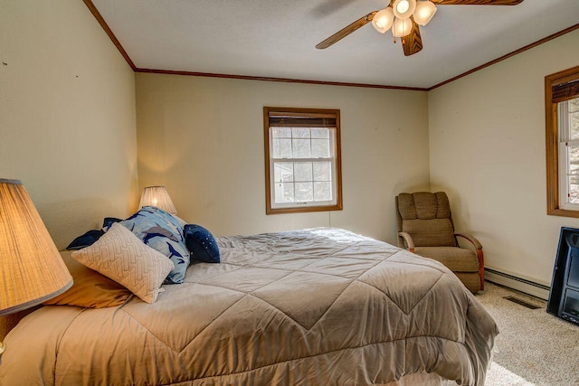 carpeted bedroom with crown molding, ceiling fan, and a baseboard heating unit