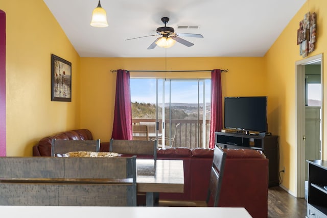 dining area with ceiling fan, lofted ceiling, a wealth of natural light, and dark wood-type flooring