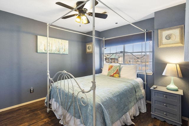 bedroom with dark hardwood / wood-style flooring and ceiling fan