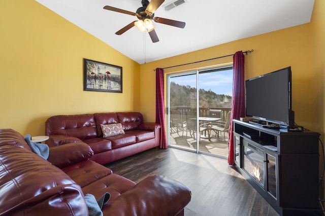 living room featuring ceiling fan, dark wood-type flooring, and vaulted ceiling