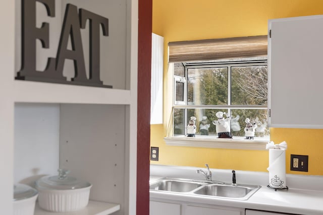 interior space with sink and white cabinets