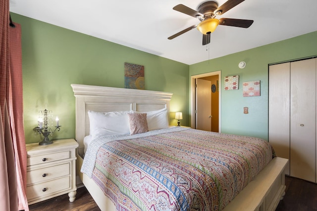 bedroom featuring ceiling fan, a closet, and dark wood-type flooring