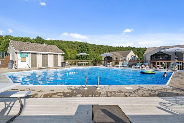 view of swimming pool featuring an outdoor structure and a patio area