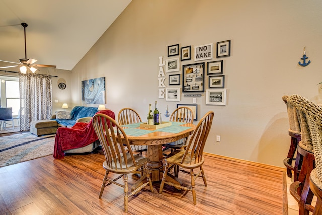 135 Upper Emerald Bay Cir Unit G-13, Hollister, MO 65672 - dining room with high vaulted ceiling, light wood-style floors, baseboards, and a ceiling fan
