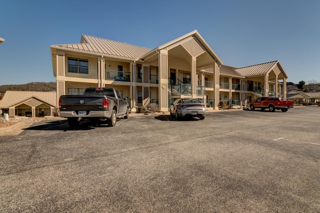 135 Upper Emerald Bay Cir Unit G-13, Hollister, MO 65672 - view of building exterior featuring uncovered parking