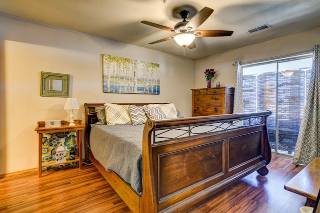 bedroom featuring access to exterior, hardwood / wood-style floors, and ceiling fan