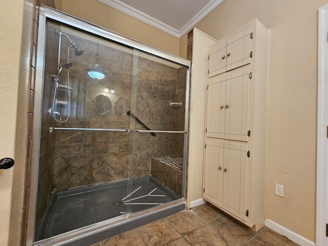 bathroom featuring crown molding and a shower with shower door