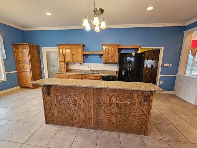 kitchen featuring sink, a kitchen island, black fridge with ice dispenser, a chandelier, and crown molding