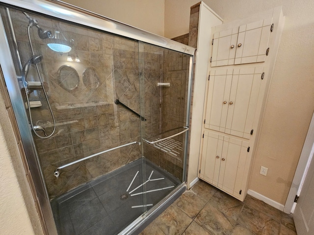 bathroom with a shower with shower door