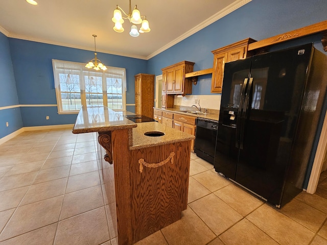 kitchen with a notable chandelier, sink, ornamental molding, black appliances, and a center island