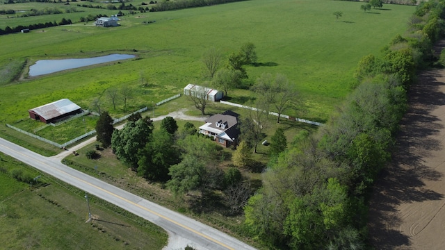 birds eye view of property with a water view and a rural view