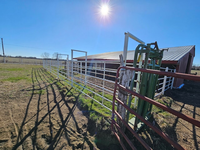 view of yard with a rural view and an outdoor structure