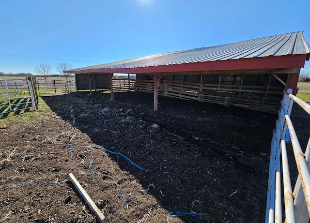 view of horse barn with a rural view