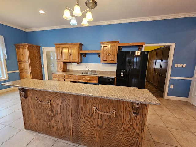 kitchen with light stone countertops, ornamental molding, black appliances, and sink