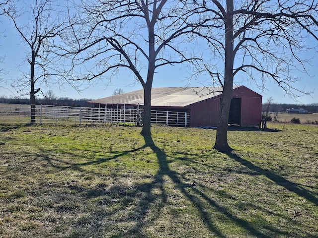 view of yard featuring a rural view and an outdoor structure