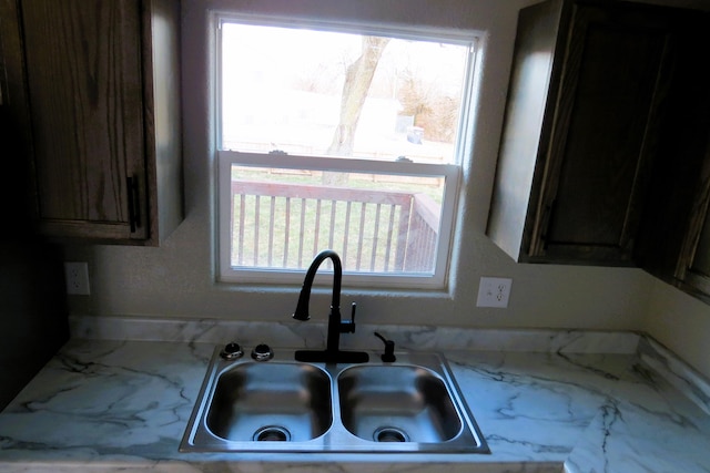 kitchen with dark brown cabinetry and sink