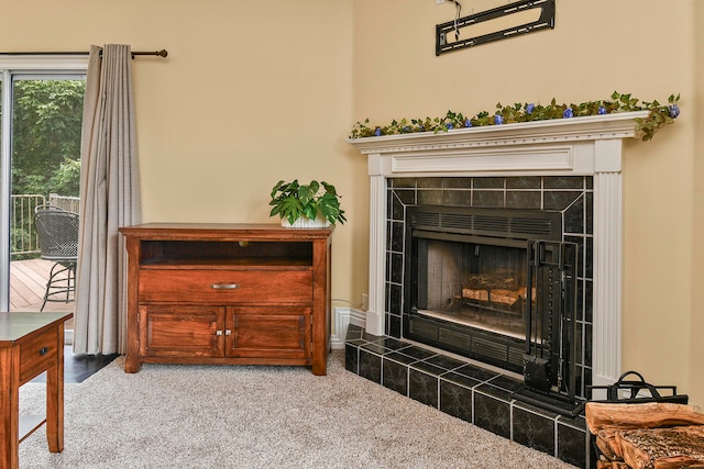 room details featuring carpet floors and a tiled fireplace