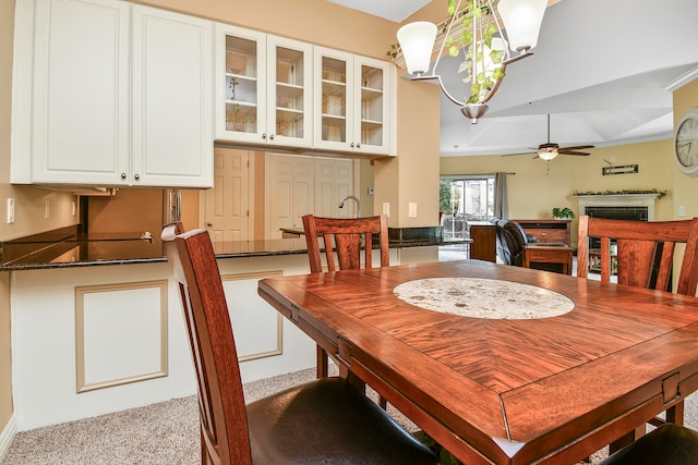 carpeted dining area featuring ceiling fan