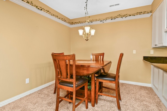 dining room featuring light carpet, a notable chandelier, and crown molding