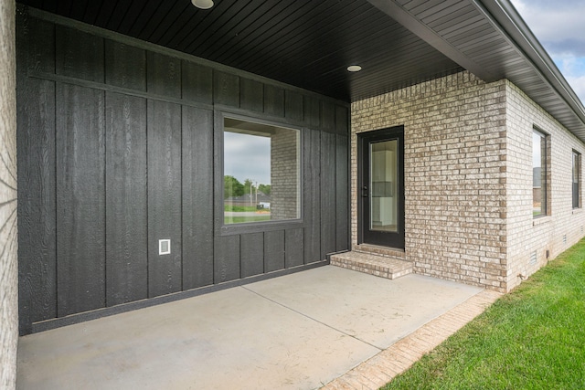 view of exterior entry featuring a patio