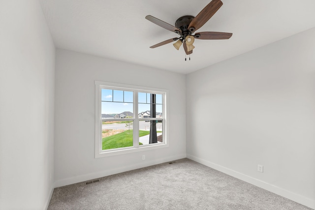 spare room with carpet floors and ceiling fan