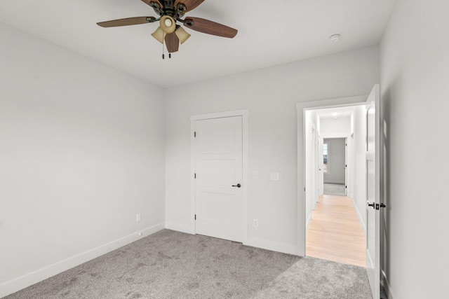 unfurnished bedroom with light carpet and ceiling fan