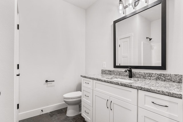 bathroom featuring vanity, tile patterned flooring, and toilet