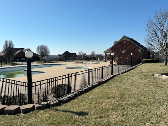 view of pool with a yard