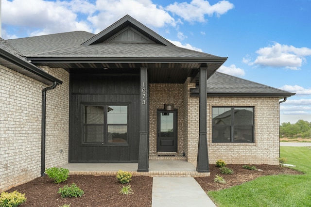 view of exterior entry with covered porch