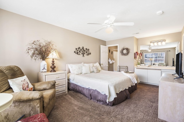 bedroom with ceiling fan and dark colored carpet