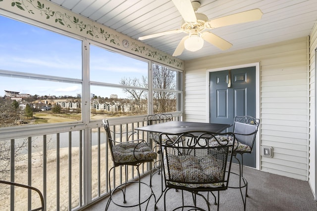 sunroom / solarium featuring ceiling fan and wood ceiling