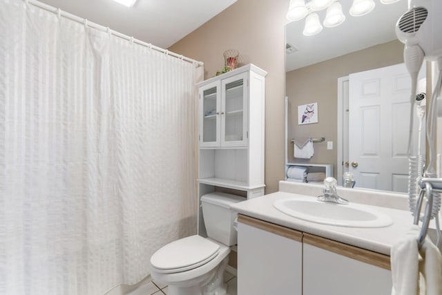 bathroom featuring tile patterned flooring, a shower with shower curtain, vanity, and toilet