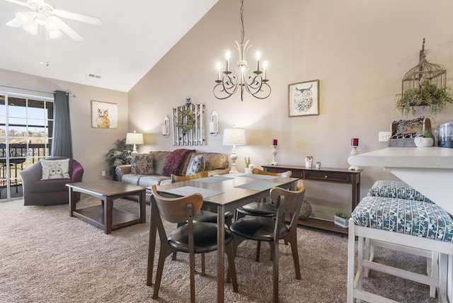 carpeted dining room featuring ceiling fan with notable chandelier and high vaulted ceiling