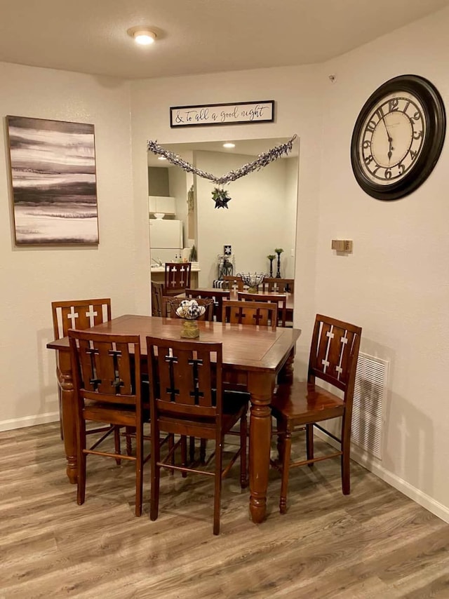 dining space featuring wood-type flooring