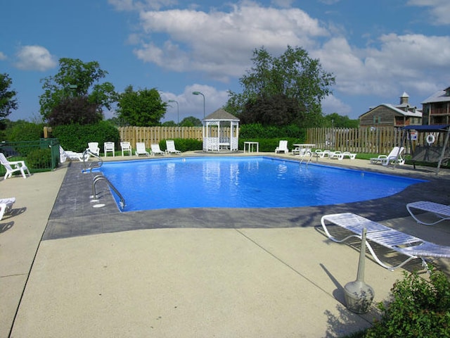 view of swimming pool featuring a gazebo and a patio