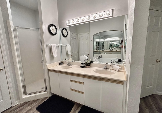 bathroom featuring vanity, separate shower and tub, and hardwood / wood-style flooring