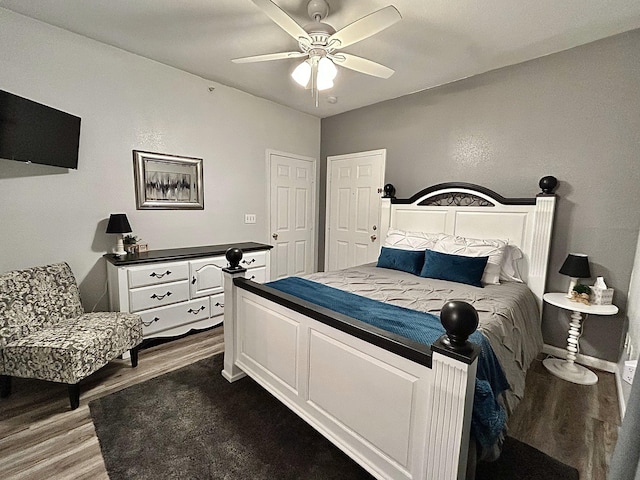 bedroom featuring ceiling fan and dark hardwood / wood-style floors