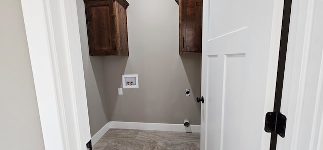 clothes washing area featuring cabinets, hookup for a washing machine, and light tile patterned flooring