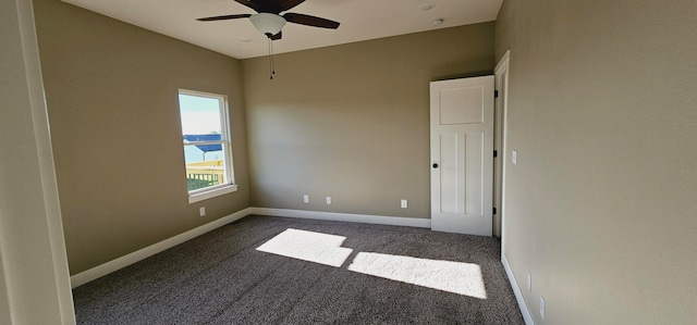 carpeted empty room with ceiling fan and a water view