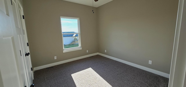 unfurnished bedroom with dark carpet