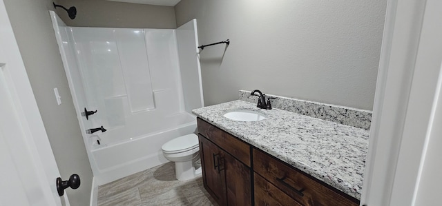 full bathroom featuring toilet, vanity, and washtub / shower combination