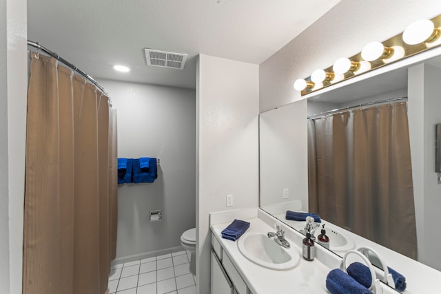 bathroom featuring vanity, toilet, and tile patterned floors